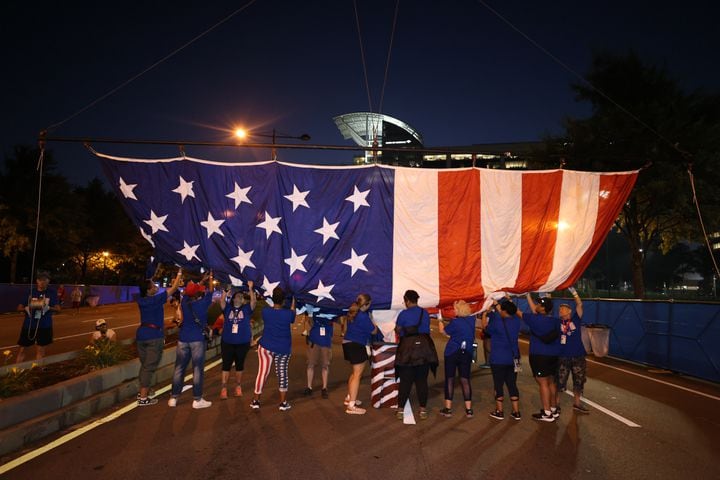A giant American flag is raised over the staring line of the 53rd running of the Atlanta Journal-Constitution Peachtree Road Race in Atlanta on Monday, July 4, 2022. (Jason Getz / Jason.Getz@ajc.com)