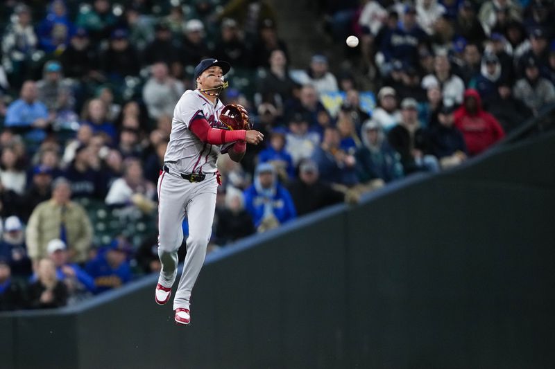 Atlanta Braves shortstop Orlando Arcia throws to second base for an out against Seattle Mariners' Cal Raleigh on a ball hit by Mariners' Ty France during the fifth inning of a baseball game Monday, April 29, 2024, in Seattle. (AP Photo/Lindsey Wasson)
