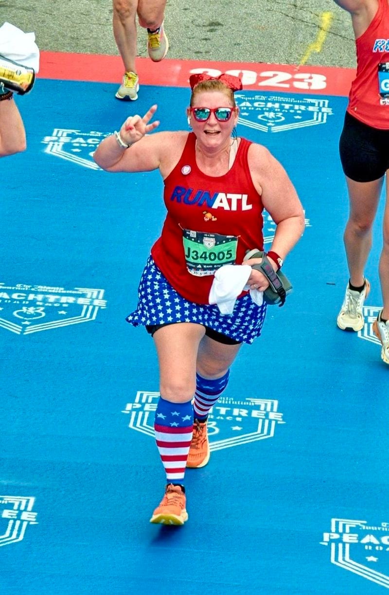 Paige Mack, a running coach with the Big Peach Running store in Alpharetta, running in the AJC Peachtree Road Race last year. Contributed