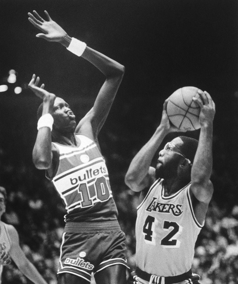Manute Bol (10) of the Washington Bullets makes a formidable obstacle for James Worthy of the Los Angeles Lakers (42) during NBA action in the Forum in Inglewood, Calif. on Sunday, Jan. 5, 1986. (AP Photo/Lacy Atkins)