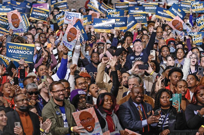 Supporters of Sen. Raphael Warnock and Former President Barack Obama cheer during a campaign rally at Pullman Yards on Thursday, December 1, 2022. (Natrice Miller/natrice.miller@ajc.com)  