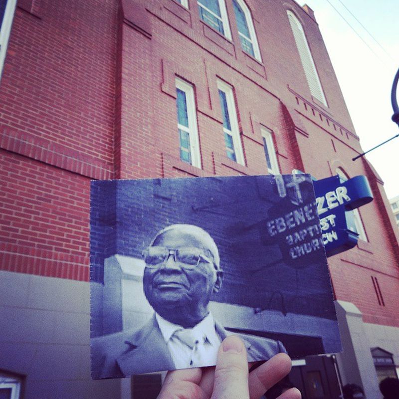 Christopher Moloney takes vintage photos and photographs them again from the same vantage point, showing the location as it appears today.Here, Martin Luther King Sr. stands in front of Ebenezer Baptist Church on Auburn Avenue. (Christopher Moloney)