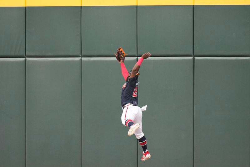 Atlanta Braves center fielder Michael Harris II makes a leaping catch at the wall on a flyout by Philadelphia Phillies Brandon Marsh to end the third inning of a spring training baseball game in North Port, Fla., Saturday, March 18, 2023. (AP Photo/Gerald Herbert)