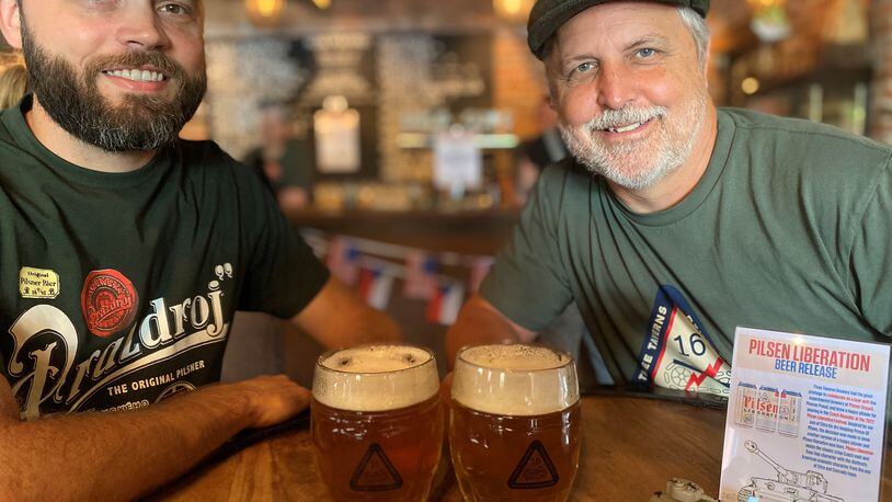 At Three Taverns in Decatur, head brewer Neal Engleman (left) and founder/CEO Brian Purcell share mugs of Pilsen Liberation. 
Bob Townsend for The Atlanta Journal-Constitution