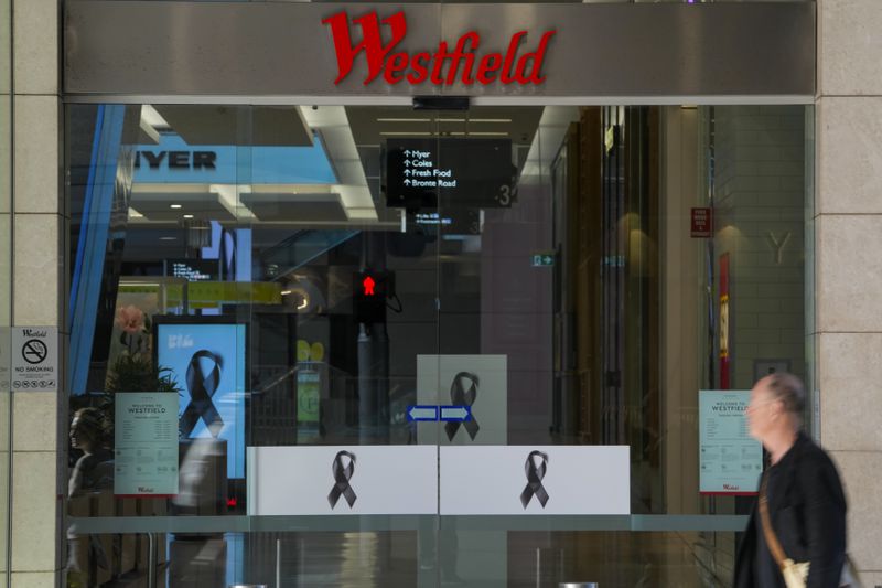 A man walks past the entrance to the Westfield mall at Bondi Junction in Sydney, Thursday, April 18, 2024. The Sydney shopping mall has been opened to the public for the first time since it became the scene of a mass stabbing in which six people died, while the Australian prime minister has flagged giving citizenship to an immigrant security guard who was injured while confronting the knife-wielding attacker. (AP Photo/Mark Baker)