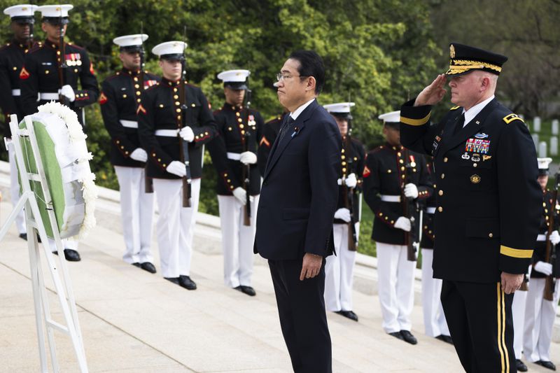 Japan's Prime Minister Fumio Kishida, with Commanding General Military District of Washington Maj. Gen. Trevor Bredenkamp, right, lays a wreath at the Tomb of the Unknown Soldier, at Arlington National Cemetery, in Arlington, Va., Tuesday, April 9, 2024. (AP Photo/Manuel Balce Ceneta)