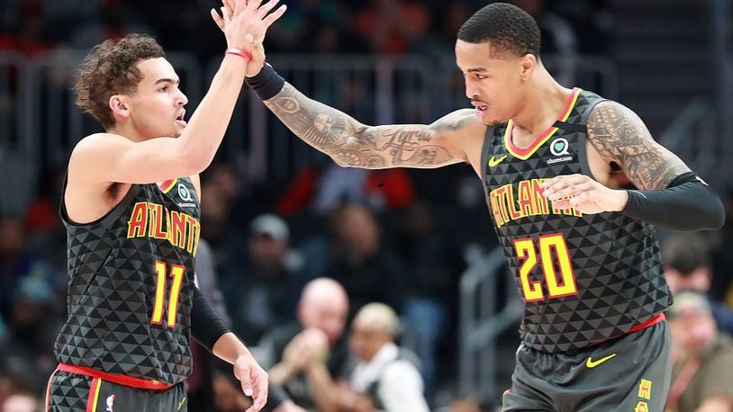 Trae Young and John Collins of the  Hawks celebrate during a 123-110 victory against the Phoenix Suns on Tuesday, January 14, 2020, in Atlanta.  Curtis Compton ccompton@ajc.com