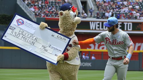 Braves' mascot Blooper plays a joke on Phillies outfielder Bryce Harper prior to their game against the Braves Sunday, June 16, 2019, at SunTrust Park in Atlanta.