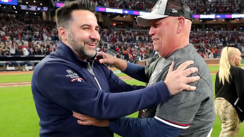 Atlanta Braves general manager Alex Anthopoulos, left, and manager Brian Snitker celebrate the Braves' 4-2 win against the Los Angeles Dodgers to advance to the World Series in Game 6 of the National League Championship Series at Truist Park, Oct. 23, 2021, in Atlanta. Curtis Compton / curtis.compton@ajc.com