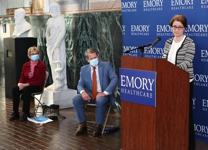DPH Commissioner Dr. Kathleen Toomey (from left) and Governor Brian Kemp look on while Dr. Nadine Rouphael, lead investigator for the Moderna vaccine trial, discusses the Moderna vaccine rollout during a press conference at Emory University on Tuesday. Curtis Compton / Curtis.Compton@ajc.com”