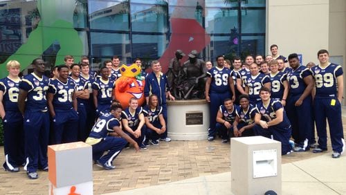 Georgia Tech players, coach Paul Johnson and the Orange Bowl mascot outside Joe DiMaggio Children's Hospital. Yes, in blue jerseys.
