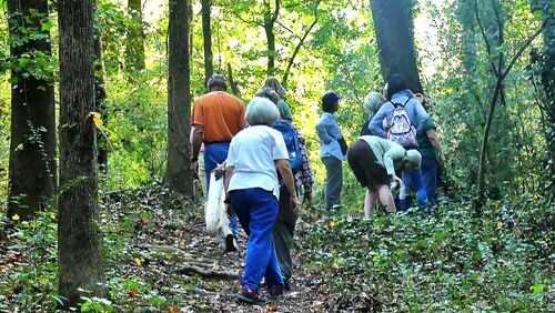 Birdwatchers take a walk in Friendship Forest Wildlife Sanctuary in Clarkston. Several new studies show that strolling in the outdoors is good for one’s mental health as well as physical health. Photo Credit: Charles Seabrook