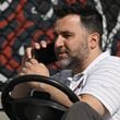 Atlanta Braves general manager Alex Anthopoulos talks on the phone during spring training workouts at CoolToday Park, Wednesday, Feb. 21, 2024, in North Port, Florida. (Hyosub Shin / Hyosub.Shin@ajc.com)