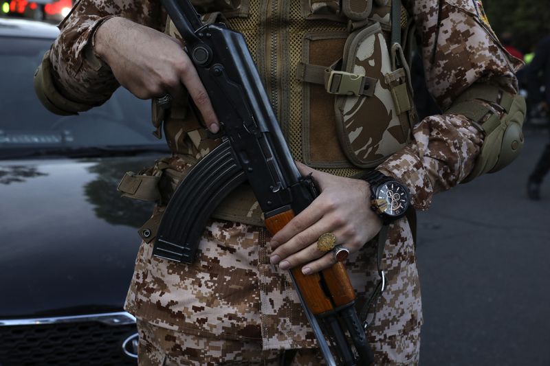 A Revolutionary Guard member stands guard during an anti-Israeli gathering at the Felestin (Palestine) Sq. in Tehran, Iran, Monday, April 15, 2024. World leaders are urging Israel not to retaliate after Iran launched an attack involving hundreds of drones, ballistic missiles and cruise missiles. (AP Photo/Vahid Salemi)