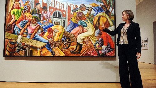 In 2012, High Museum American art curator Stephanie Heydt gives a tour of the exhibit "Rising Up: Hale Woodruff's Murals at Talladega College." Here, she talks about one of the murals in the "Founding" series, "The Building of Savery Library, " from 1942. BITA HONARVAR / BHONARVAR@AJC.COM