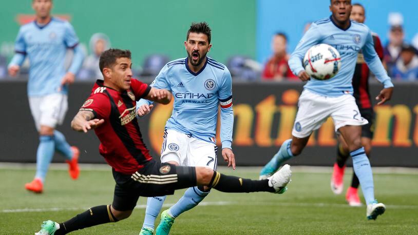 Atlanta United midfielder Carlos Carmona, left, of Chile defends New York City FC forward David Villa (7) of Spain center as New York City FC Rodney Wallace watches, right, during the first half of an MLS soccer game, Sunday, May 7, 2017, in New York. (AP Photo/Kathy Willens)