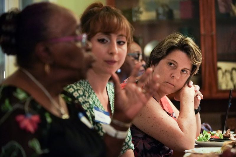 Clare Schexnyder, right, listens as Sarah Dansby speaks about her experience growing up during a dinner conversation on race as part Decatur Dinners on Sunday, Aug. 25, 2019, in Decatur. The dinner was one of 100 being held simultaneously across Decatur to talk about race and equity. (Elijah Nouvelage for The Atlanta Journal-Constitution)