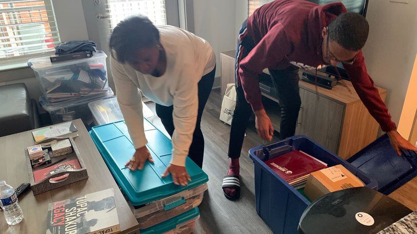 Morehouse College senior John Bowers (right) and his mother, Rhetta Andrews Bowers, a state representative from Dallas, Texas, pack up his belongings from his off-campus apartment on Tuesday, March 17, 2020. Bowers, Morehouse’s student government association president, has been helping students who need temporary housing and other resources as Morehouse and other colleges close their campuses in response to the coronavirus outbreak.