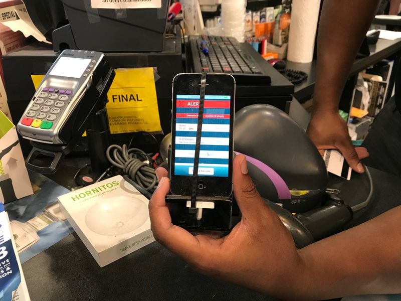 Employees at Mac’s Beer and Wine in Atlanta now have a better way to check for fake and altered IDS. CREDIT: SHELIA POOLE