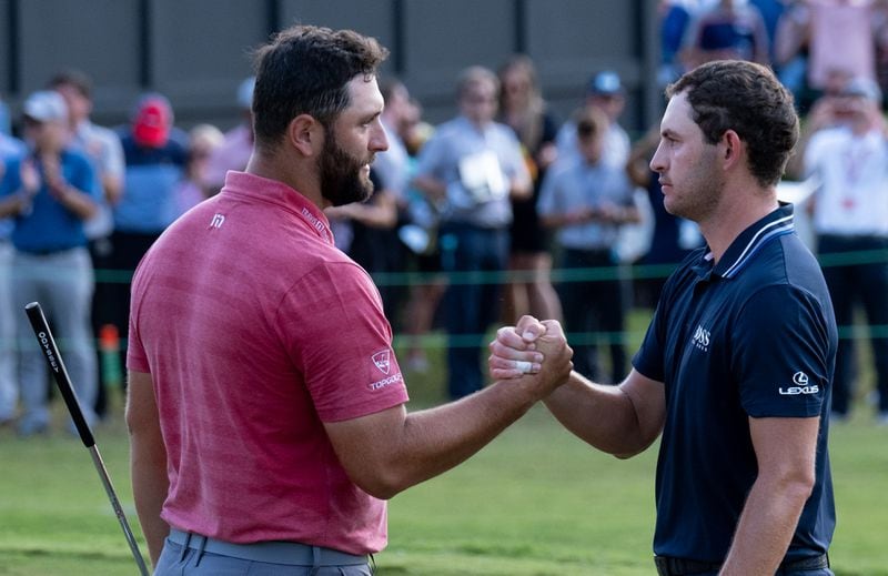 Jon Rahm (left) congratulates Patrick Cantlay after he won the PGA Tour Championship Sunday, Sept. 5, 2021, at East Lake Golf Club in Atlanta. (Ben Gray/For the AJC)