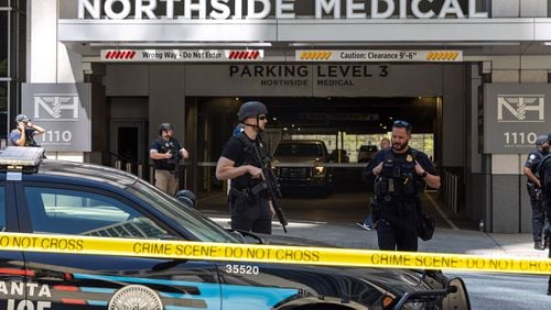 Law enforcement officers are seen on West Peachtree Street in front of Northside Hospital Midtown medical office building, where five people were shot on Wednesday, May 3, 2023. (Arvin Temkar/The Atlanta Journal-Constitution/TNS)