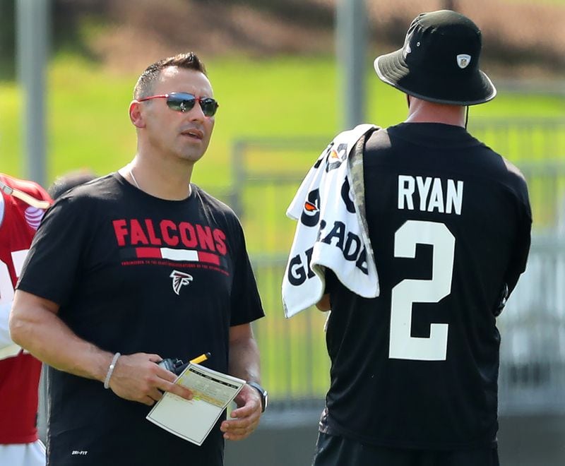 July 27, 2017 Flowery Branch: Falcons offensive coordinator Steve Sarkisian confers with quarterback Matt Ryan on the first day of team practice at training camp on Thursday, July 27, 2017, in Flowery Branch. Curtis Compton/ccompton@ajc.com