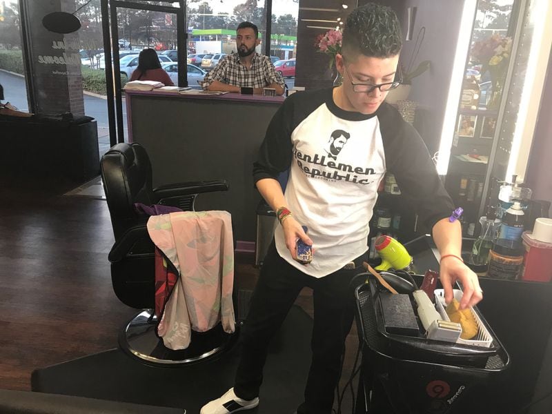 Jonathan Jimenez, a stylist at The House of Jolie Hair Salon, cleans up his work station on Feb. 24, 2018. TIA MITCHELL/TIA.MITCHELL@AJC.COM