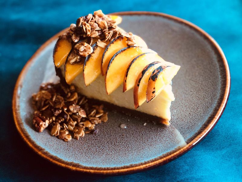 Georgia peaches and pecans really shine in Banshee’s cheesecake, served with bruleed fruit and nutty granola. CONTRIBUTED BY NOLAN WYNN