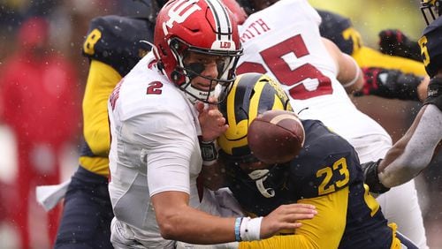 Indiana's Tayven Jackson (2) fumbles the ball in the second half while being hit by Michigan's Michael Barrett (23) at Michigan Stadium on Saturday, Oct. 14, 2023, in Ann Arbor, Michigan. (Gregory Shamus/Getty Images/TNS)