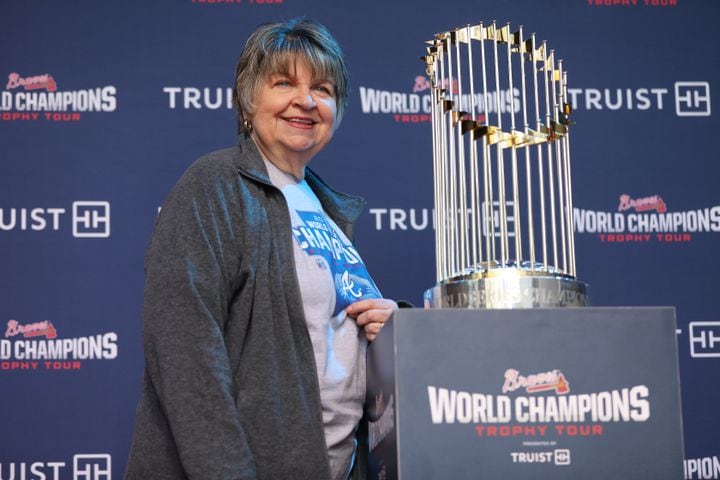 Debbie Reeves from Atlanta stands beside the 2021 World Champions Trophy. Miguel Martinez for The Atlanta Journal-Constitution 