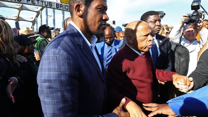 March 1, 2020 Selma: U.S. Rep. John Lewis, D-Atlanta, is helped walking from the Edmund Pettus Bridge while making an appearance and speech during Selma's er-enactment of Bloody Sunday on Sunday, March 1, 2020, in Selma. Curtis Compton ccompton@ajc.com