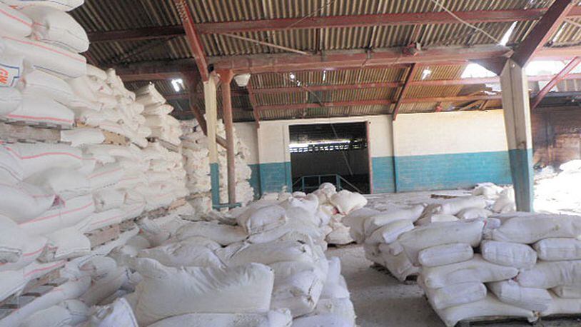 Tons of flour sit in a warehouse in Port-au-Prince with little way to get it to aid workers and starving people.