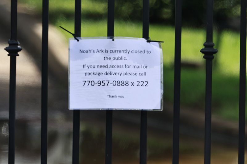 A “closed to the public” sign hangs on the gates of Noah’s Ark Animal Sanctuary in Locust Grove on Monday, August 22, 2022. (Natrice Miller/natrice.miller@ajc.com)