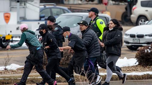 Shoppers are evacuated from a King Soopers grocery store after a gunman opened fire on March 22, 2021 in Boulder, Colorado. Dozens of police responded to the afternoon shooting in which at least one witness described three people who appeared to be wounded, according to published reports.