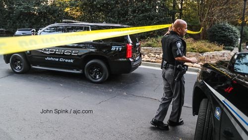 An investigation into a body found inside a burning car in Gwinnett County led authorities to  the Retreat at Johns Creek apartments in north Fulton County.