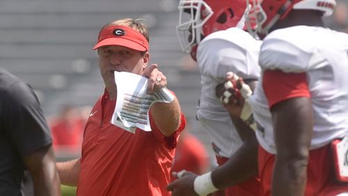 UGA coach Kirby Smart talks to a group of Bulldogs during the annual fan day  at Sanford Stadium on Saturday.