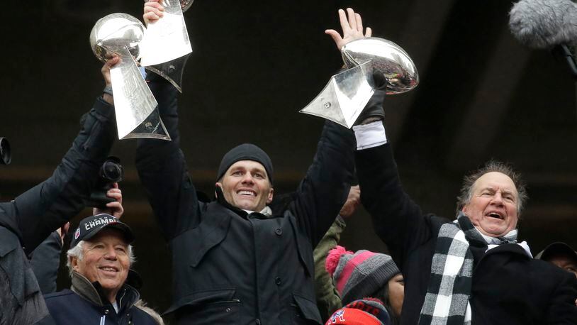 New England Patriots quarterback Tom Brady holds up a Super Bowl trophy along with head coach Bill Belichick and team owner Robert Kraf after last season’s championship, the franchise’s fifth since the 2001 season.