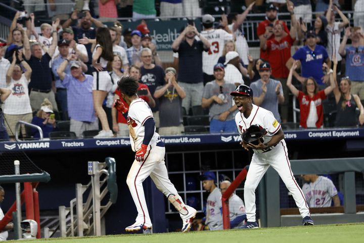 The celebration continued as Albies rounded third and prompted a huge smile from third base coach Ron Washington. (Miguel Martinez / miguel.martinezjimenez@ajc.com 