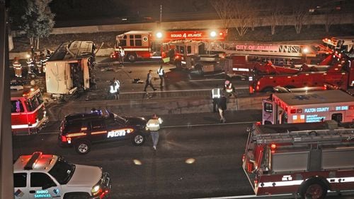 070302 - ATLANTA/ FULTON COUNTY, GA -- A charter bus, reportedly carrying members of a baseball team from Ohio, crashed onto I-75 from an overpass at Northside Drive early Friday morning, March 2, 2007 . (JOHN SPINK / AJC staff)