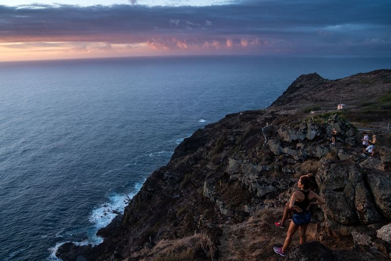 Hikers watch the sunrise on Oahu. (Kent Nishimura/Los Angeles Times/TNS)