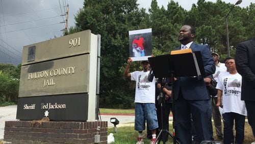 Attorney Michael Harper speaks at a news conference Tuesday, calling on the Fulton County district attorney's office to launch an investigation into the death of Antonio May.