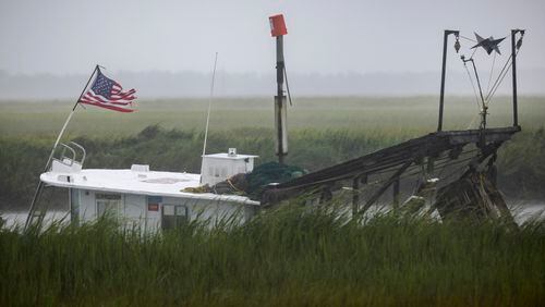TYBEE ISLAND, GA - AUGUST 30, 2023: A small fishing boat lays at anchor near Tybee Island during Hurricane Idalia, Wednesday, Aug. 30, 2023, in Tybee Island, Ga. The coast is due for a full moon King Tide Wednesday evening just as the system passes nearby. (AJC Photo/Stephen B. Morton)