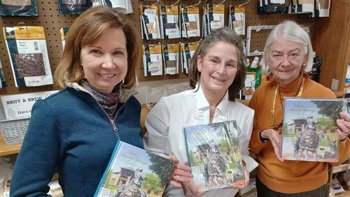 Handling the logistics of getting cookbooks into Sandy Springs Society members’ hands are Laura Jones, Gail Jokerst and Trudy Keenan. The trio were among the members working on the distribution at Keenan’s business, Sandy Springs Boutique Winery. (Photo Courtesy of Bob Pepalis)