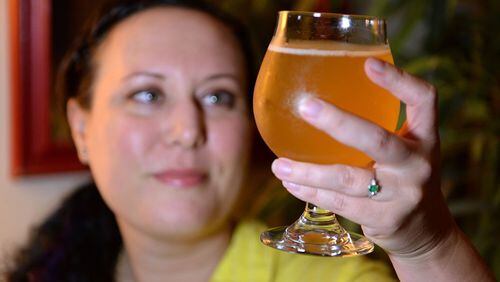 Jen Blair holds a glass of the finished grisette that she began brewing on June 17, 2017. She is a home brewer who just accepted a job in the beer industry as the executive director of the Craft Maltsters Guild of North America. (Jenna Eason/Charlotte Observer/TNS)