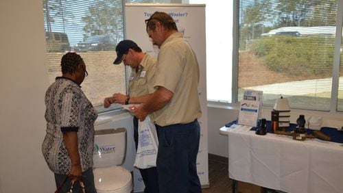 Meter Services staff members show customers how to check their toilets for leaks and how to make simple repairs during Fix a Leak Week. CONTRIBUTED
