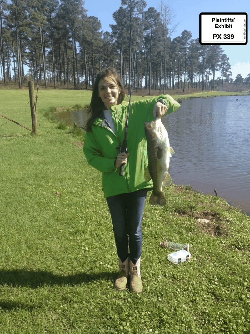 Suzanne Wynn is shown in 2015 holding a fish caught in a lake on property now owned by Shaun and Amie Harris. The lake has since been turned red-brown by sediment runoff from a nearby solar project. (Courtesy of Scott Badcock)