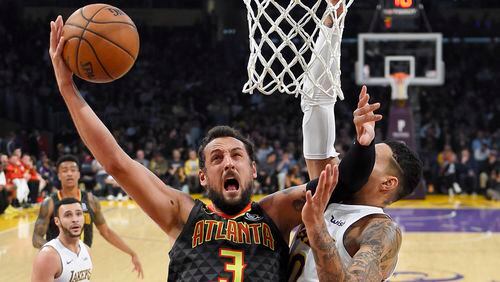 Atlanta Hawks guard Marco Belinelli shoots as Los Angeles Lakers forward Kyle Kuzma defends during the first half of a basketball game, Sunday, Jan. 7, 2018, in Los Angeles. (AP Photo/Mark J. Terrill)