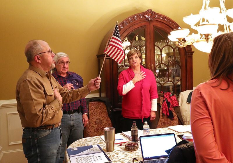 Donald Trump supporter Ronny West (left) leads the Pledge of Allegiance during a Georgia Tea Party Incorporated meeting at the home of one of the group’s members just before Christmad, in Acworth. Curtis Compton/ccompton@ajc.com