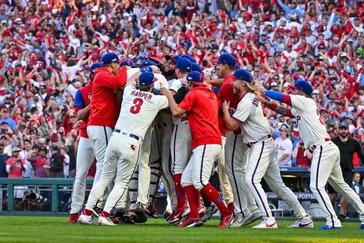 The Phillies celebrate their 8-3 win over the Braves in Game 4 of the NLDS on Saturday at Citizens Bank Park in Philadelphia. (Hyosub Shin / Hyosub.Shin@ajc.com)