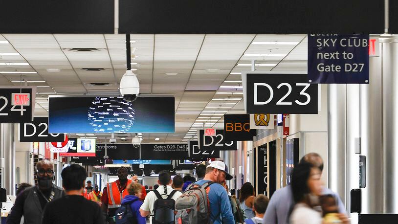 Passengers walk through Concourse D at Hartsfield-Jackson International Airport on Thursday, July 7, 2022.  (Natrice Miller/natrice.miller@ajc.com)